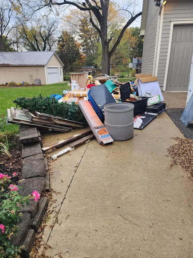 Dumpster being loaded with debris for Estate Cleanout Dumpster Rental in Killingly